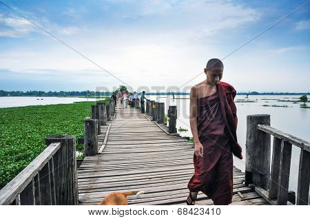 Mandalay, Myanmar - October 9, 2013: Unidentified Young Monk Walking On U Bein Bridge, Myanmar.