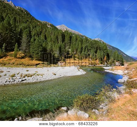 Austrian Alps. Headwaters of the famous Krimml waterfalls. The crystal clear transparent water glows in the midday sun