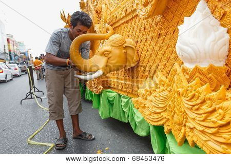 Unidentified thai people candle Carver on the traditional candle procession festival of Buddha.