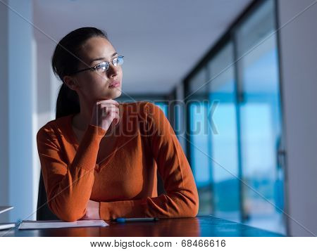 beautiful young woman relax and work on laptop computer while listening music on heaphones and read book at home
