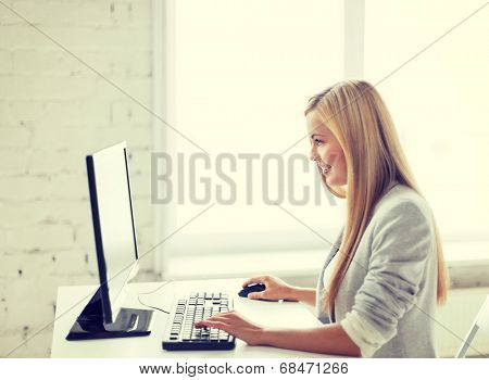 picture of smiling businesswoman with computer in office