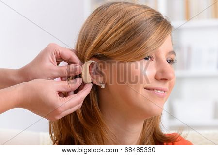 Putting on a deaf aid