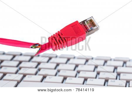 defective network cable on keyboard, symbolic photo for online, networks, interference and espionage