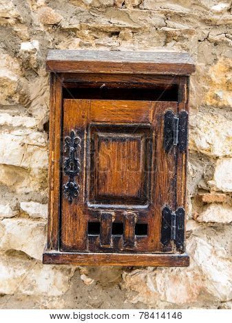 age letter box made of wood on a house wall