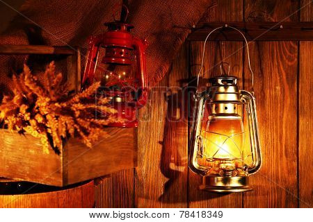 Lantern hanging on hook on wooden wall