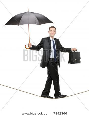 傘と綱渡りにブリーフケースを持って事業者