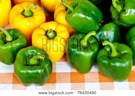 Close Up Of Green And Yellow Bell Pepper Or Sweet Pepper Or Capsicum  On The Table
