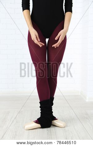 Ballerina in pointe shoes in dance hall