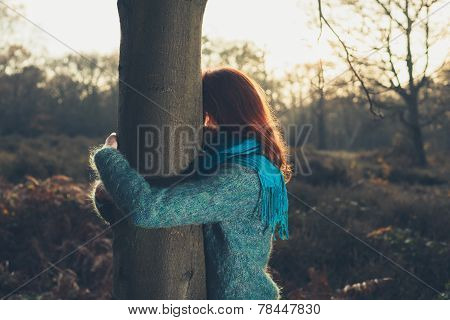 Woman Hugging Tree At Sunset