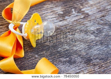 baby pacifier on wooden table