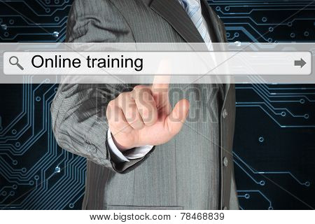 Businessman pushing virtual search bar with online training words