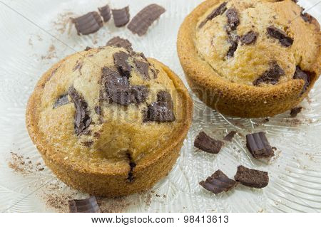Chocolate Muffins Decorated With Chocolate And Coconut On A Plate On The White Table