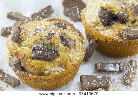 Chocolate Muffins Decorated With Chocolate And Coconut On Background