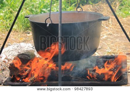 Cauldron with soup on fire
