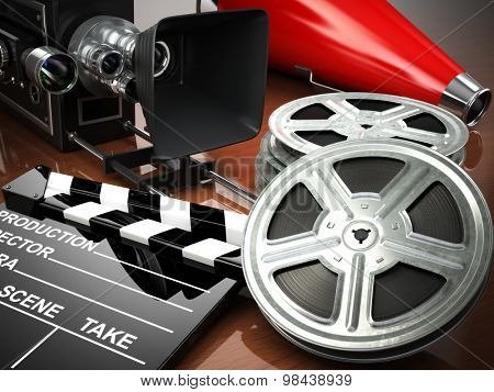 Video, movie, cinema vintage concept. Retro camera, reels and clapperboard. 3d