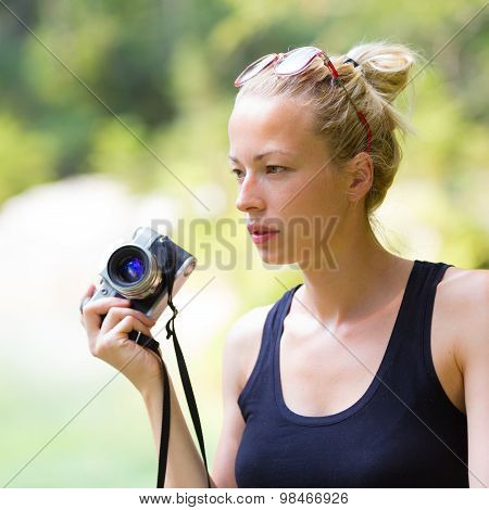 Woman in nature with retro camera.