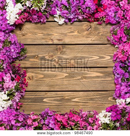 Lilac flowers on wooden background