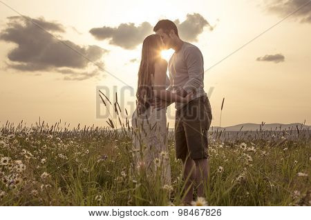 Young couple in love outdoor at the sunset