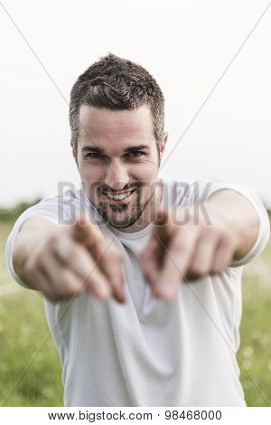 Happy young man in a field