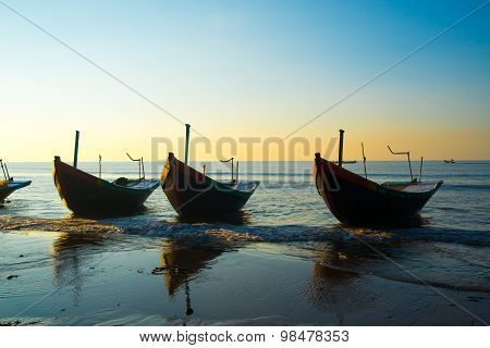 A row of boats on beach