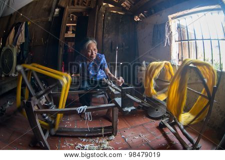 Old woman are weaving silk