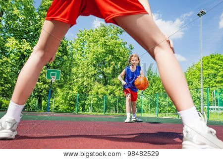 Girl with ball view between two legs of player