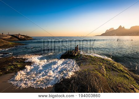Waves Washing the Arpoador Rock During Sunset in Rio de Janeiro