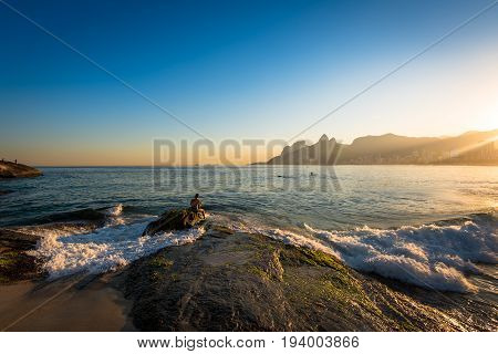 Waves Washing the Arpoador Rock During Sunset in Rio de Janeiro