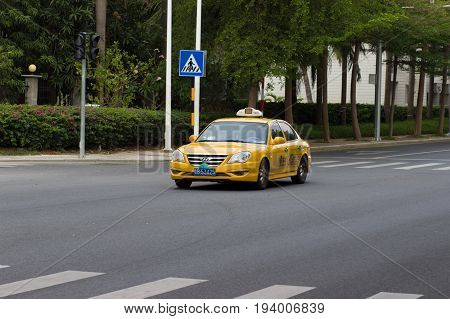 Sanya China April 23 2017 - Car taxi service brand Hyundai Sonata yellow on the asphalt road of Hainan Island