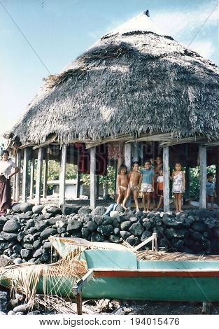 SAVAI'I / SAMOA - CIRCA 1990: Native Samoan children pose for a photograph from inside an open home in a village.