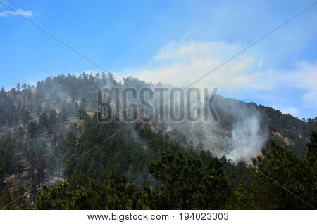 Smoldering Smoky Forest Fire in the Mountains