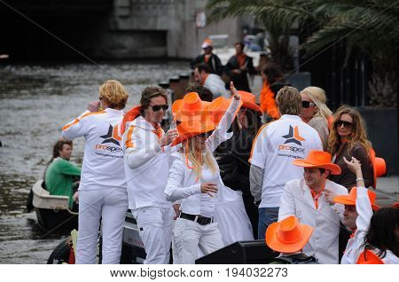 AMSTERDAM, NETHERLANDS - APRIL 30. Young People Celebrating Queensday in Amsterdam. Queensday is a popular annual festival celebrating the Queens Birthday.