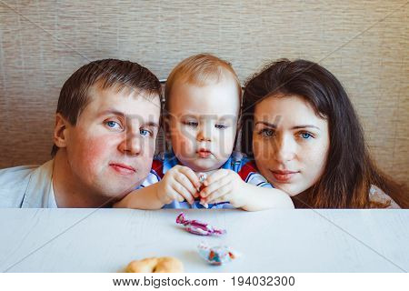 baby reaching shiny foil wrapped hard candy