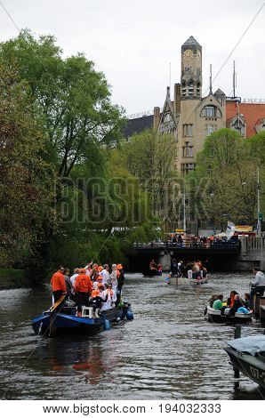 AMSTERDAM, NETHERLANDS - APRIL 30. Young People Celebrating Queensday in Amsterdam. Queensday is a popular annual festival celebrating the Queens Birthday.