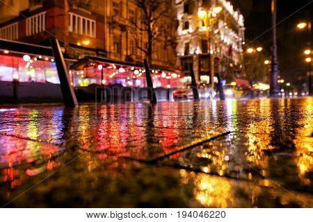 Rainy weather in Budapest at night Hungary. Reflcetion of lights on pavement