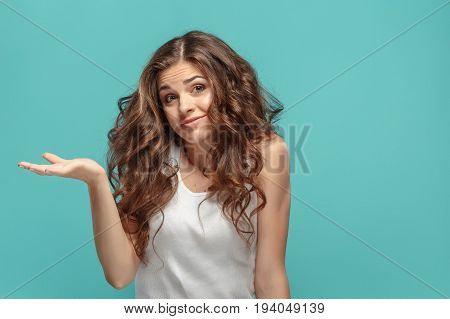 The portrait of alarmed young woman with shocked facial expression Presenting something