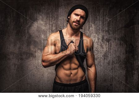 Athlete training in a gym portrait on a wall - Functional training workout