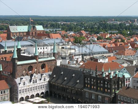Top view of the beautiful old city with red-tiled roofs and spires