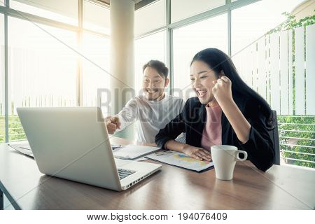 Asian couple business people with casual suit working with happy action in office Business people concept.
