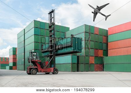 Forklift lifting container box loading to container depot use for cargo import export logistics background with cargo airplane flying above container depot near logistics port.