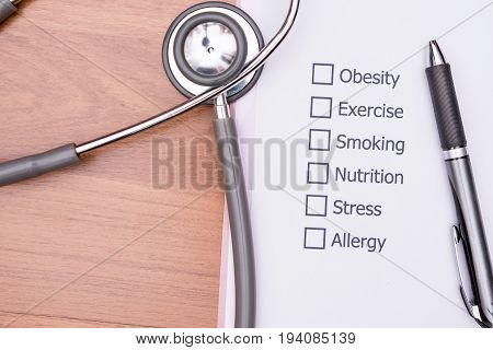 On the doctor's desk, Doctor assess the patient's history and what are the risks to cause a disease with his Diagnose Form.