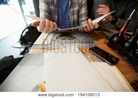Birmingham, UK - 6 November 2016: Man Sitting At Table Looking At Wagamama Restaurant Menu