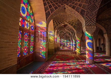 SHIRAZ IRAN - OCTOBER 23 2016 : Colorful light through stained glass window inside Nasir Al-Mulk Mosque (Pink Mosque) a traditional mosque in Shiraz Iran.