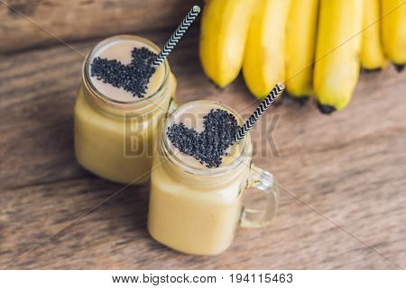 Banana Smoothies And Bananas On An Old Wooden Background