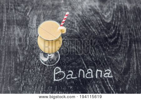 Banana Smoothies And Bananas On An Old Wooden Background