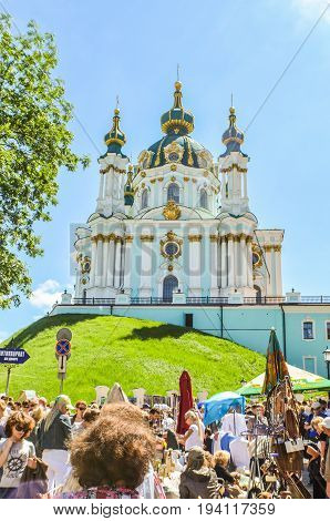 Kiev Ukraine - May 25 2013: View of St Andrew's Church on a hill called Andriyivskyy Descent with many tourists
