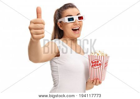 Joyful girl with 3D glasses and popcorn making a thumb up gesture isolated on white background