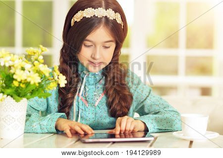 Portrait of  Beautiful little girl with tablet pc