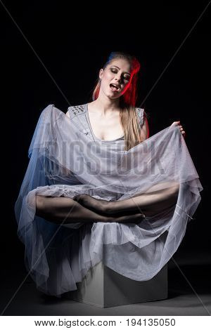 Actress In A Grey Dress On A Dark Stage