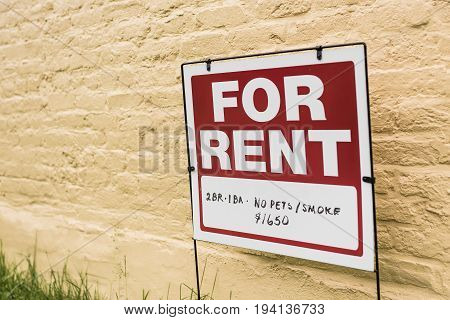 Red For Rent sign with price and no pets or smoking